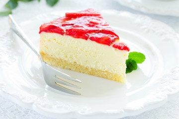 Delicious strawberry cheesecake on a white background.