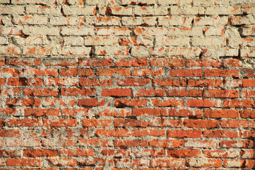 detail of old brick wall lighter in the upper part useful as background texture