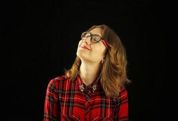 Obraz premium Portrait of a young beautiful girl close-up in a red checkered shirt with various emotions on her face