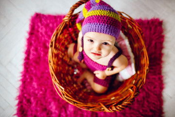 Look from above at little girl sitting in the basket