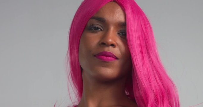 Black women dancing in pink wig