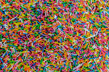 Multicolored background from sugar powder for Easter.