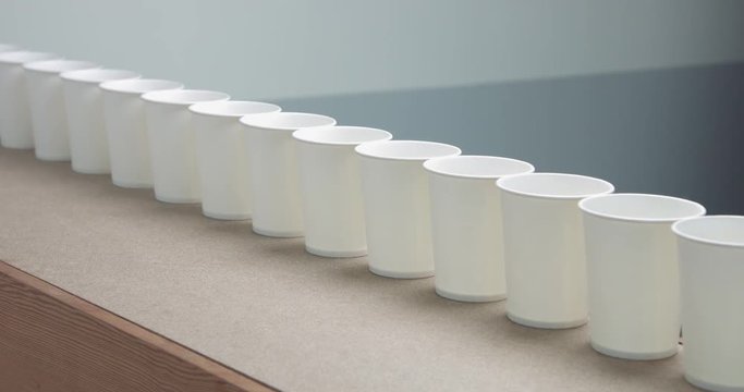 row of paper cups goes to blur