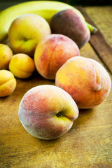 Fototapeta na wymiar Fresh peaches, apricots and banana on the table
