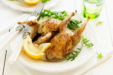 Delicious fried quail with herbs and greens.