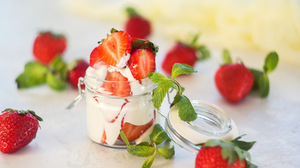 Healthy dessert with fresh strawberries and yogurt. Strawberries with sour cream. Smoothie in the jar