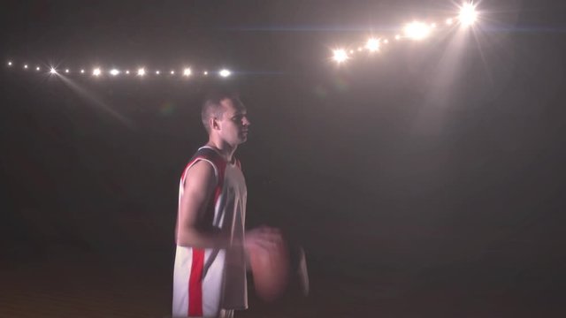 basketball player make free throw shot behind stadium flash lights