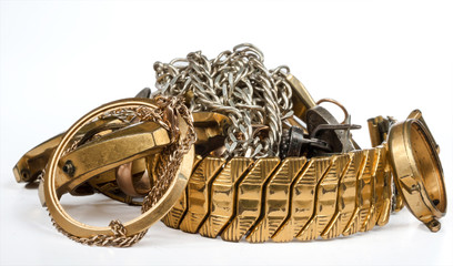 A scrap of gold. Old and broken jewelry, watches of gold and silver are isolated on a white...
