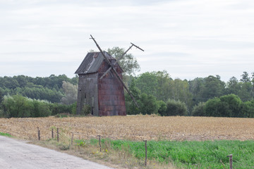 Fototapeta na wymiar Kawnice, Poland. Old ruined windmill on the field.