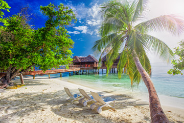 Table and chairs at the beach on tropical island in Indian ocean, Maldives