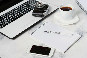 Office Desk with computer, phone, camera, Cup of coffee and peony flowers. Coffee break, ideas, notes or plan of writing concept. White background. The view from the top