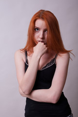 Fototapeta premium Busty woman in studio photo on gray background. Sexuality and sensuality. Attractive model