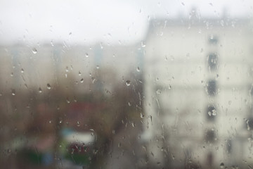 View of the city through a wet window glass