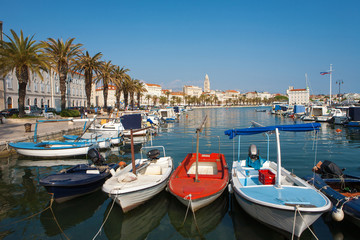 Fototapeta na wymiar Split city's harbor with colorful boats and the Diocletian Palace in the background