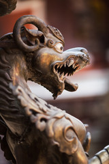The growling mythical lion made of bronze, in the ancient Buddhist temple Golden Templ, Lalitpur,...