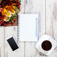 Phone, coffe and notebook for planning