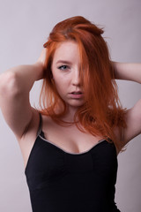 Fototapeta premium Beautifu hotl busty woman in studio photo on gray background. Sexuality and sensuality. Attractive model