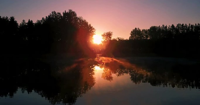 sunrise over the forest and lake. Morning landscape