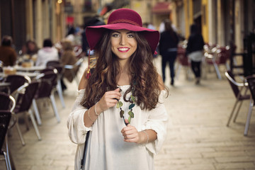 beautiful standing on street with hat