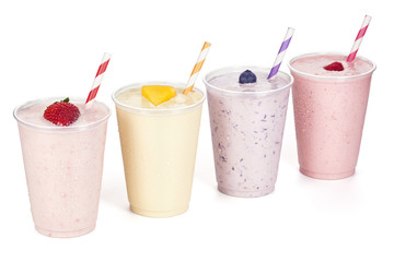 Four Flavors of Fruit Yogurt Smoothies on White Background