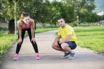 Man helps to woman with injured knee at sport activity