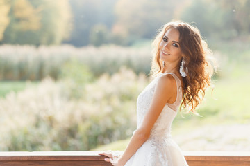 Fototapeta na wymiar Beautiful young bride with long curly hair