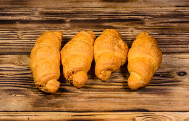 Fresh croissants on wooden table