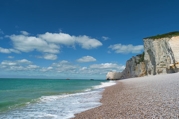 Beach, blue sea and cliffs in Etretat, France