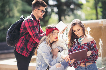 Fototapeta premium Group Of Students Chatting Together In Park