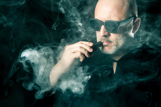 A man smokes an electronic cigarette.