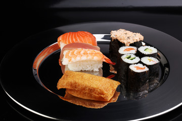 close up of sashimi sushi set with chopsticks and soy - sushi roll with salmon and sushi roll,...