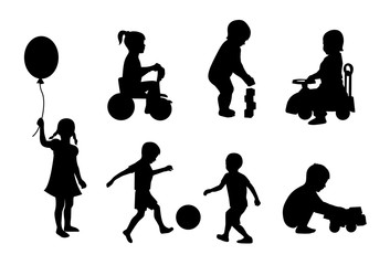 Set of black silhouettes playing children on a white background