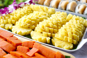pineapple papaya dragon fruit on buffet line