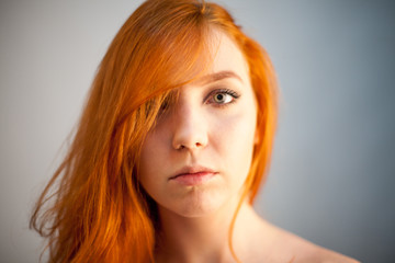 Naklejka premium Dreammy portrait of redhead woman in soft focus in studio photo. Attractive and beautiful woman