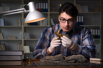 Archeologist working late night in office