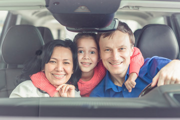 Happy international family buying a car at the dealership