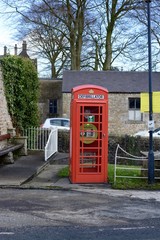 A emergency defibrillator being used in a old style UK red phone box in the small village of Waddington, Lancashire, UK