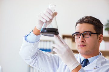 Chemical engineer working on oil samples in lab