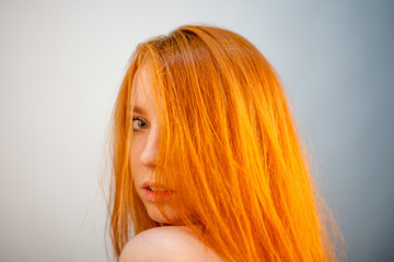 Naklejka premium Dreammy portrait of gorgeous redhead woman in soft focus in studio photo. Attractive and beautiful woman
