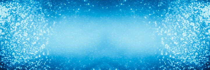 Abstract shimmering bokeh or glitter lights on blue background. Circles and defocused particles. Template for design