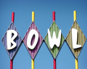 vintage neon bowl sign on bowling alley