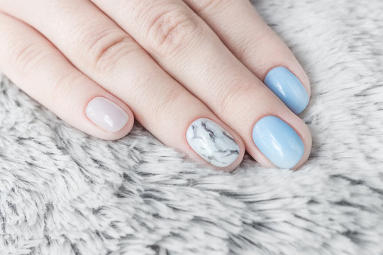 Professional nail manicure blue sky color and marble texture. Shaggy white background