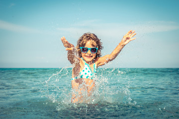 Happy child playing in the sea