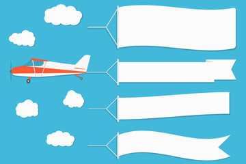 Flying advertising banner. Plane with horizontal banners on blue sky background.