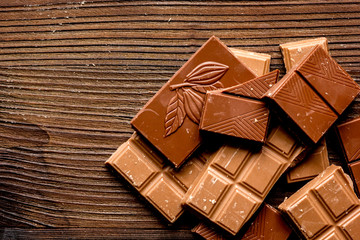 black and milk chocolate pieces wooden table background top view mock up
