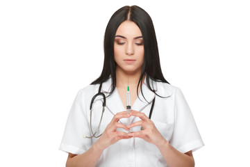 Beautiful serious nurse holding syringe with vaccine.