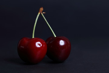 Cherry fresh on black background close up.