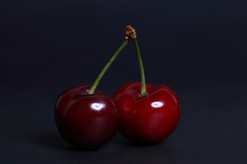Cherry fresh on black background close up.