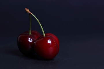 Cherry fresh on black background close up.