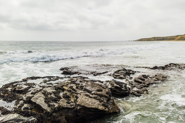 Rocks overlooking beach shoreline.

